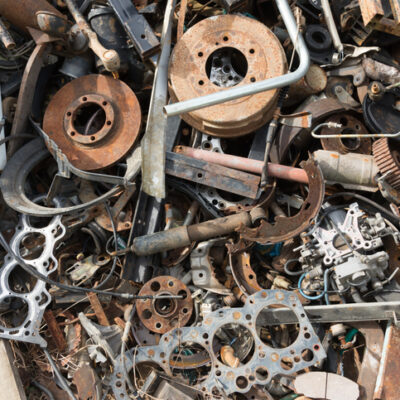 Old rusty corroded car parts in car scrapyard. Car recycling.Wrecking Machinery Parts wait for reused or to be a part for repair.